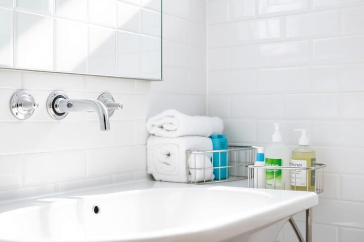 Spotless white bathroom with polished chrome taps